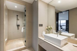 A modern bathroom with a glass-enclosed shower, two sinks, and a large mirror. - Minzhong Grand Hotel (Youxi)
