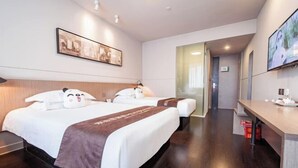 A hotel room with two beds, a desk, a TV, and a painting on the wall.