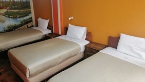 A hotel room with three single beds, wooden headboards, and a mural of a landscape on the wall. - RIXAA Hotel (La Paz)