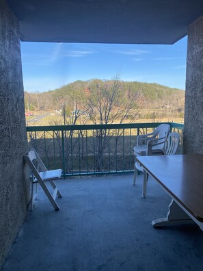 Enjoy a serene view of the surrounding hills from this balcony.