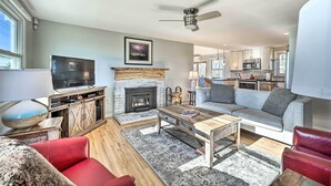 A modern living room with a fireplace, a television, and a sofa.
