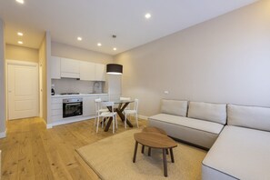 Un appartement moderne comprenant une cuisine, un coin repas et un salon.