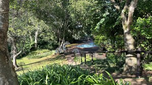 A pool area surrounded by lush greenery and trees. - Greenway woods Self Catering unit no 9, WhiteRiver (White River)