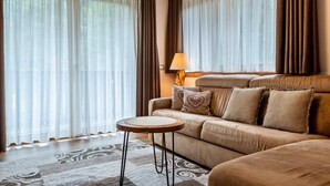 Un salon avec un canapé, une table basse ronde et une lampe.