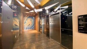 A modern elevator area with a marble floor and a mural on the wall. - Elite 1BD/1BTH in Miami W/FREE PARKING! (Miami)