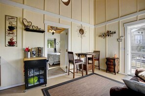 Enjoy a warm and inviting living space with a dining area, storage cabinet, and large window offering a view of the surroundings.