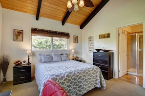 A bedroom with a bed, nightstands, a dresser, and a window with blinds. - Charming Kailua-Kona Apartment Near Hiking & Golf! (Kailua-Kona)