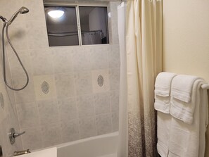 Combined shower/bathtub, hair dryer, towels, soap