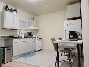 Fridge, microwave, stovetop, coffee/tea maker