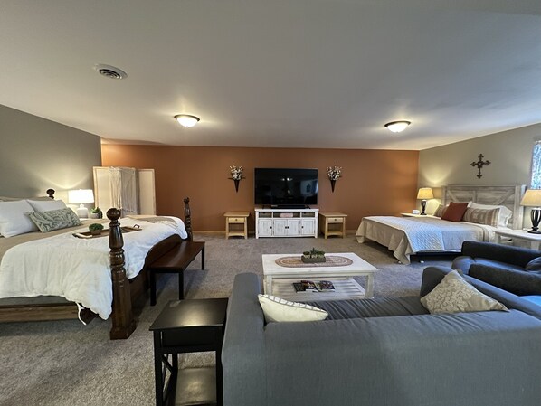 A well-lit, modern living room with two beds, a sofa, and a TV. - Private Large Suite, cozy, quiet & close to I-75 (Lebanon)
