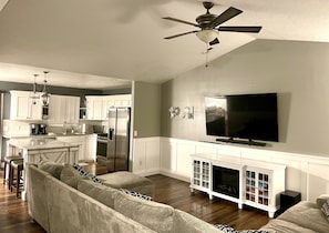 Enjoy a comfortable stay in this cozy living space with a large flat-screen TV, fireplace, and fully equipped kitchen.