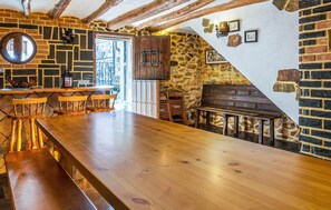 Relax by the stone fireplace in this cozy space, featuring a long bar and comfortable seating.