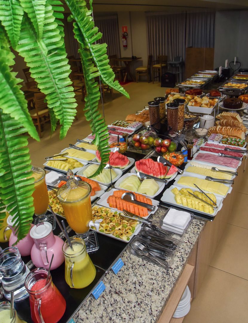 A buffet with various food items and drinks.