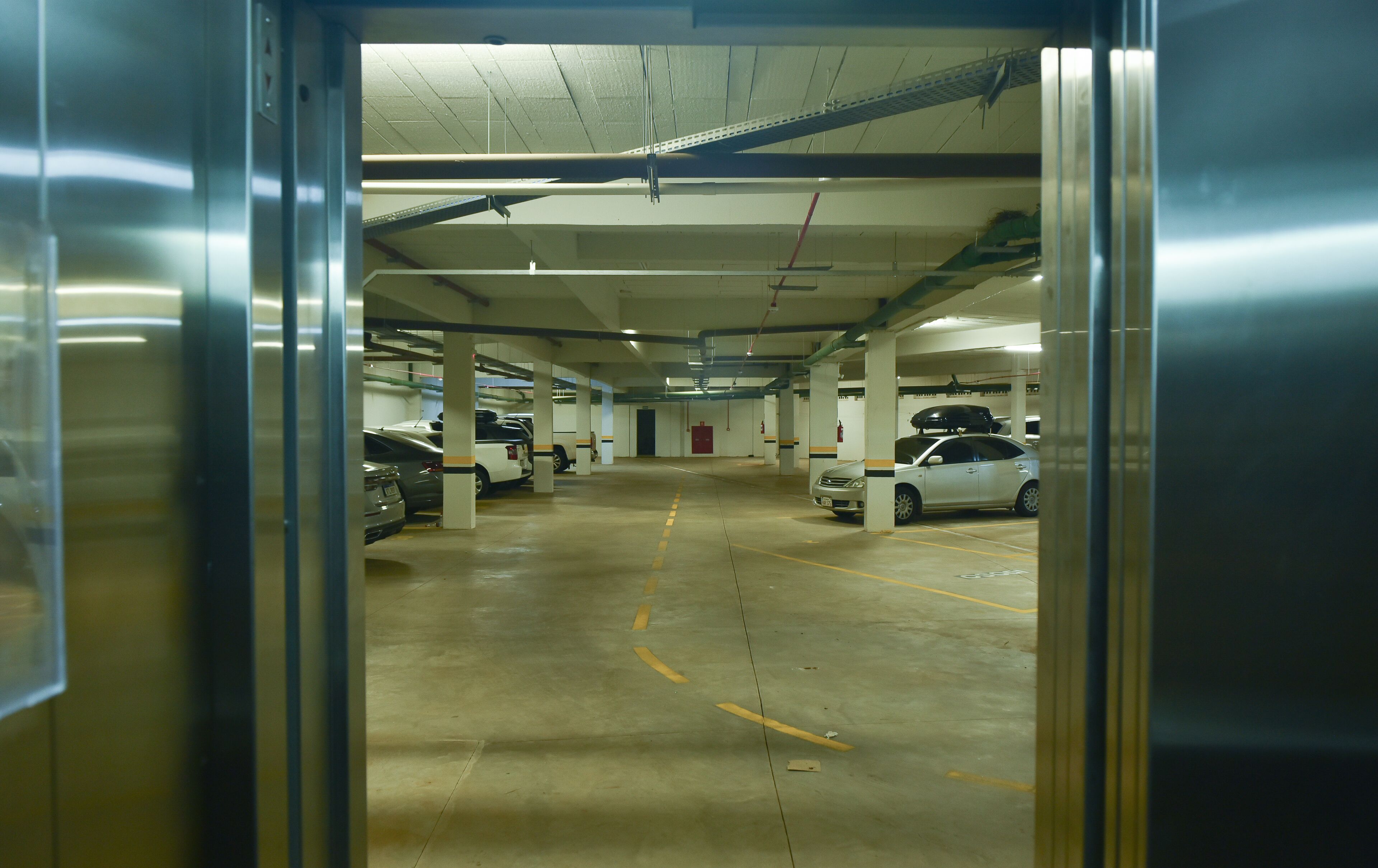 A multi-level parking garage with several cars parked.