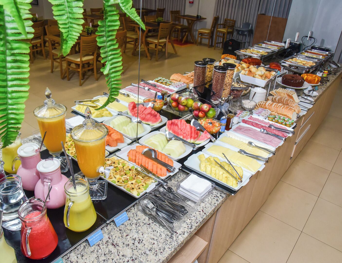 A buffet with various food items and drinks.
