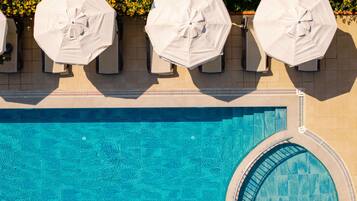 Seasonal outdoor pool, open 8:00 AM to 7:00 PM, pool umbrellas