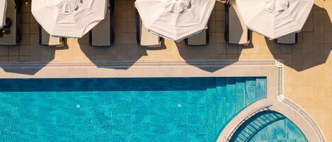 Seasonal outdoor pool, open 8:00 AM to 7:00 PM, pool umbrellas