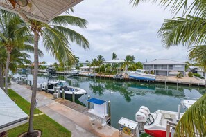 A marina with boats docked, surrounded by palm trees and houses. - Key Colony Beach Rentals, Fl, Boat Dock, Sleep 10 - 5 Bedrooms, Waterfront, Pool (Key Colony Beach)