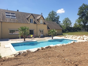 A house with a swimming pool, patio furniture, and a lawn. - Villa with private pool and jacuzzi, lovely view (Herry)