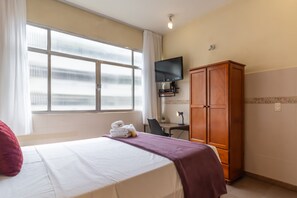 A hotel room with a bed, a desk, a television, and a wardrobe. - 5 Minutes From Copacabana Beach Stc905 (Rio de Janeiro)