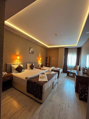 A hotel room with two beds, a desk, a chair, and a large window with curtains. - Pointbreak Hotel (Trabzon)