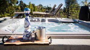 A hot tub with lounge chairs, a decorative vase, and a metal pot on a wooden board. - Amazing Views with Heated Pool and Jacuzzi Near Beach (Solana Beach)