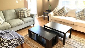 A living room with two sofas, a coffee table, and a side table.