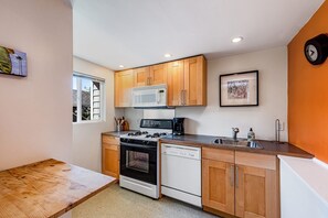 Enjoy cooking in this functional kitchen with a microwave, stove, and dishwasher.