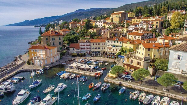 A coastal town with a marina filled with boats, historic buildings, and a mountainous backdrop. - Beach front apartment in Opatija with WiFi (Opatija)