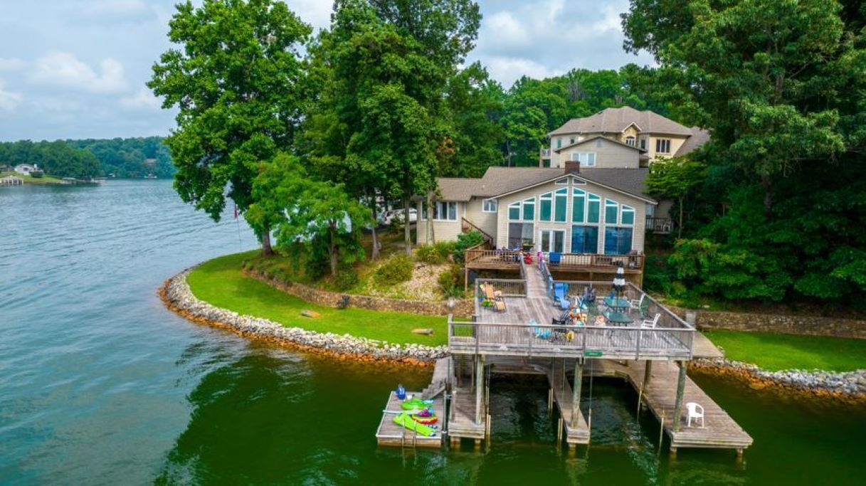 Lakefront point with a private cove, beach & 2 story boat dock “On Easy Street”
