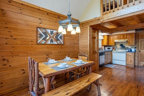 Cozy dining area with a wooden table and chairs, perfect for meals and gatherings.