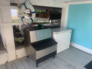 A compact kitchen with a stainless steel refrigerator and a built-in sink. - Waterfront island retreat (Placida)