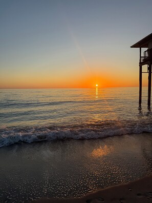 A sunset over a calm sea with a wooden pier extending into the water. - Waterfront island retreat (Placida)