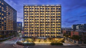 A modern hotel building with a prominent 'HYATT PLACE' sign, multiple floors, and a well-lit facade. - Hyatt Place Shanghai Lingang (Shanghai)