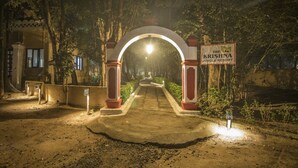 An entrance to The Krishna Jungle Resort with a central archway and a signboard. - Krishna Jungle Resort  (Bichhiya)
