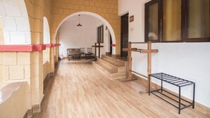 A corridor with a wooden floor, brick walls, and a staircase leading to an upper level. - Krishna Jungle Resort  (Bichhiya)