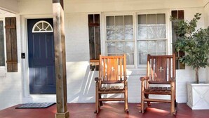 A porch with two wooden chairs, a door, and a window. - Corporate Stay: 5BR, Guest Suite & Fast WiFi (Decatur)