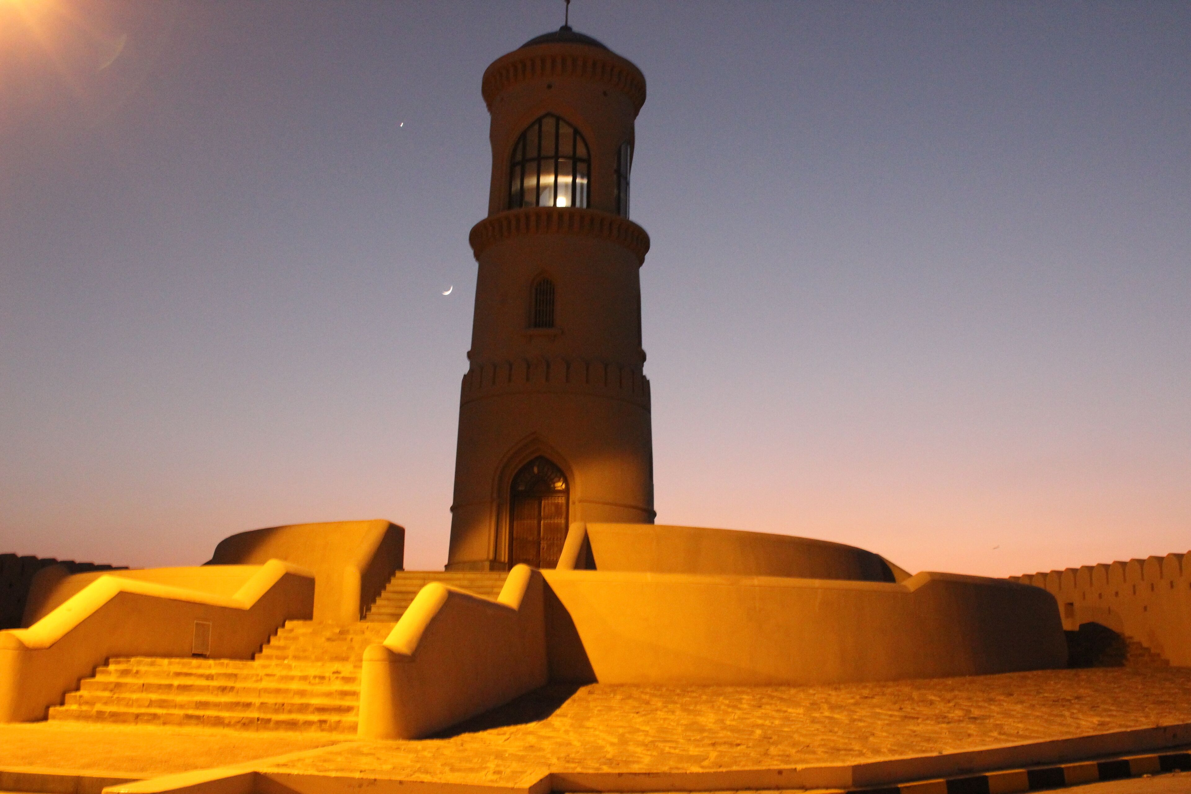 A tower with a staircase leading up to a door, surrounded by walls.