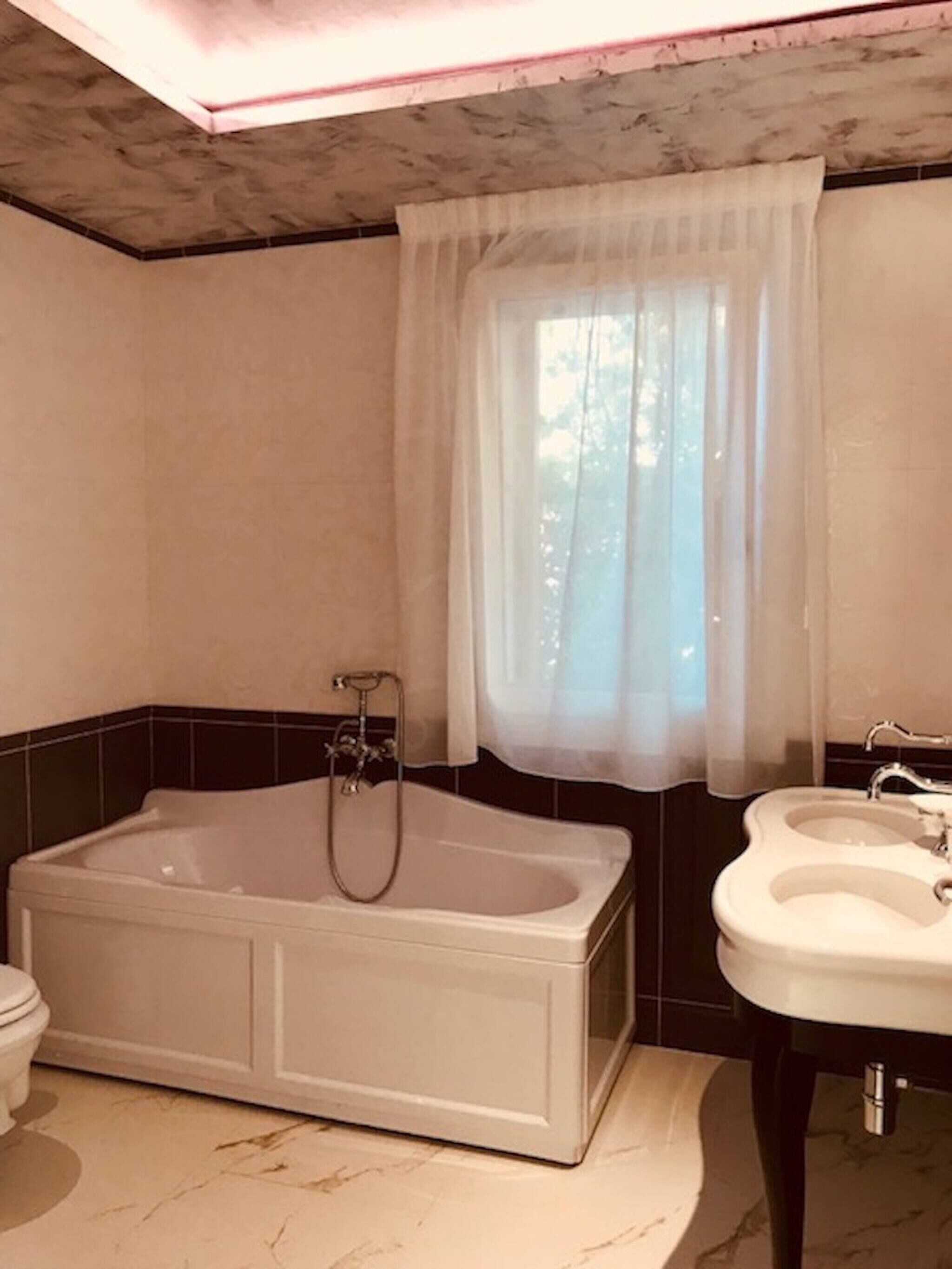 A bathroom with a bathtub, a sink, and a toilet.