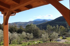 A wooden structure with a view of a mountainous landscape and trees.