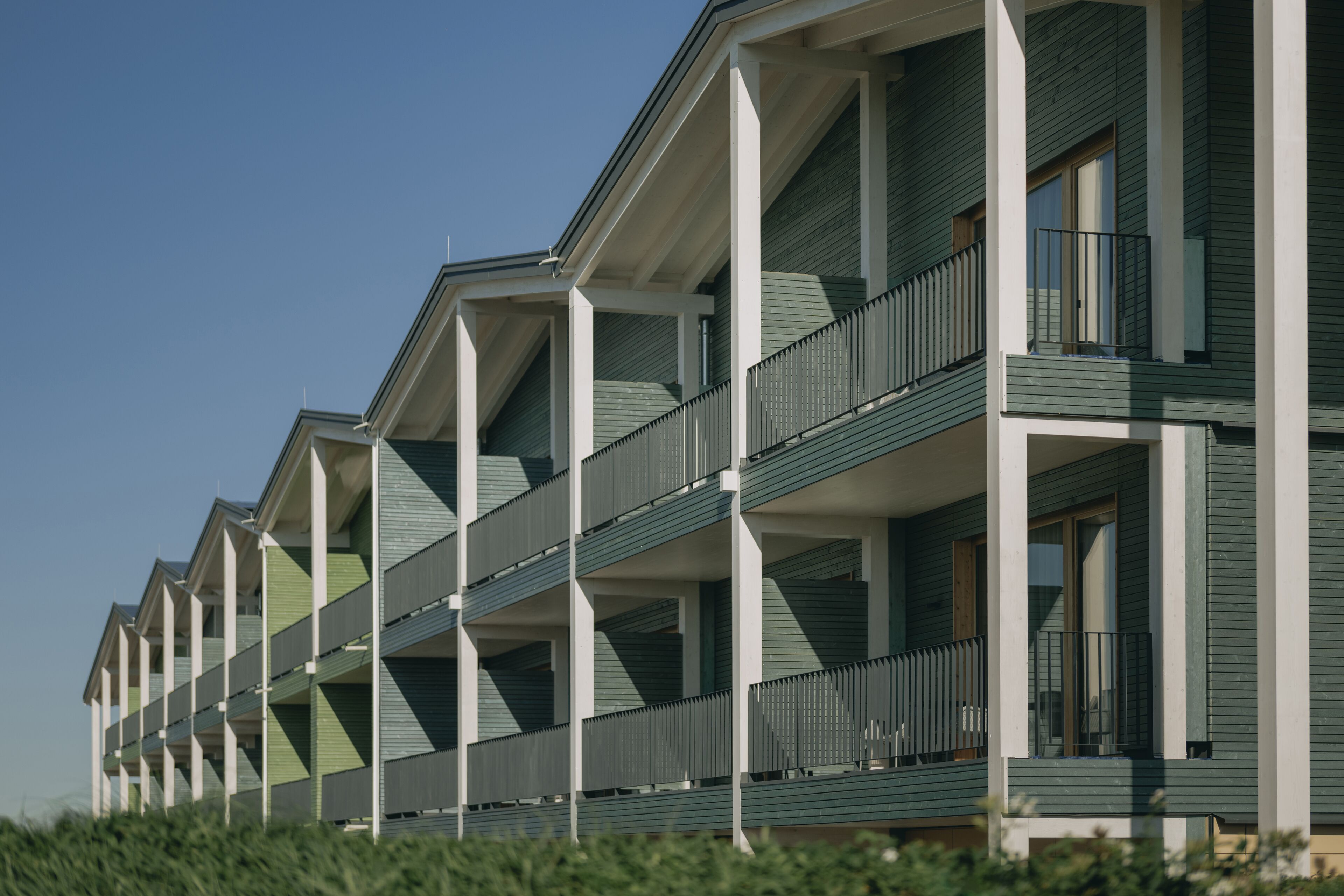 A row of multi-story buildings with balconies, likely part of a hotel or residential complex.