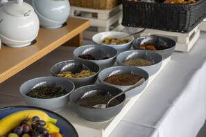 A breakfast buffet with various food items and bowls.