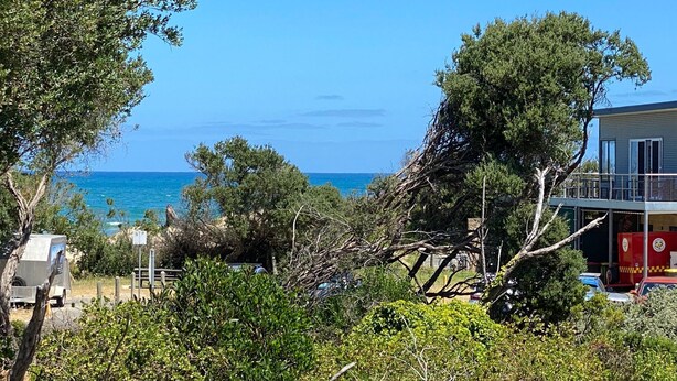A coastal property with a view of the sea, surrounded by dense vegetation and a building with a balcony. - After Dune Delight, Indulge in your Ocean views. (Inverloch)