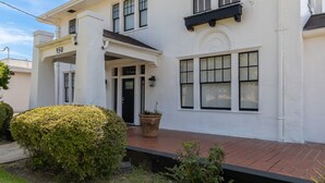 A white building with a number '950' on the facade, a front porch, and a potted plant. - Royal Resort (Jackson)