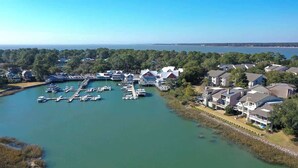 A marina with boats docked, surrounded by residential buildings.