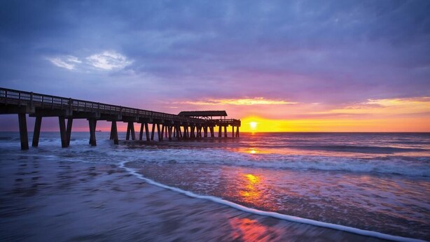 A pier extending into the ocean at sunset. - ⭐Southern Charmer•Historic Downtown•Private Porch⭐ (Savannah)