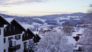 A snow-covered landscape with buildings and trees. - One-room vacation apartment in vacation park with swimming pool (Missen-Wilhams)