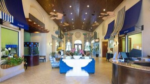 A spacious lobby with a reception desk, seating area, and a large decorative fountain. - Resort acess walking distance - Private pool (Kissimmee)