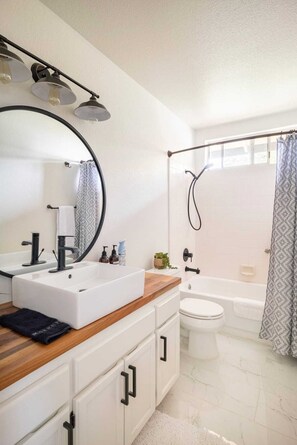 Combined shower/tub, hair dryer, towels, soap