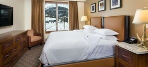 Relax in comfort with a large bed, dresser, and flat-screen TV.